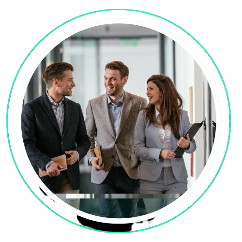 Smiling business professionals walking and talking in office hallway.